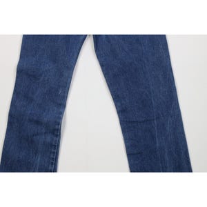 Puede incluir: Un par de vaqueros azules. Los vaqueros tienen un dise&ntilde;o cl&aacute;sico de cinco bolsillos y un corte de pierna recta. El denim tiene un lavado medio con sutiles decoloraciones y desgaste.