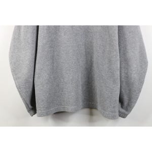 May include: A heather gray sweatshirt with long sleeves. The garment has a crew neck and ribbed cuffs and hem. The fabric appears to be a soft, comfortable material, suitable for casual wear. The sweatshirt is a solid color.