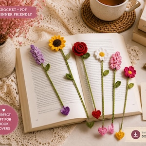 May include: A selection of handmade crochet flower bookmarks in various colours, including yellow, red, pink, and purple, displayed on an open book. The bookmarks have green stems and heart-shaped accents. Text on the image reads "CROCHET • PDF BEGINNER FRIENDLY" and "PERFECT GIFT FOR BOOK LOVERS."