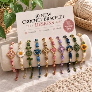 May include: Ten crochet bracelets displayed on a cylindrical stand, featuring various colors and shapes including flowers, hearts, and moons. A sign behind them reads 10 NEW CROCHET BRACELET DESIGNS and PATTERN PDF, with icons for handmade, adjustable, and unique features.