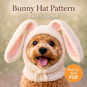 May include: A small, brown dog wearing a cream-colored crocheted bunny hat with pink inner ears. The hat is part of a pattern labeled "Bunny Hat Pattern" and "Easy Crochet". A small orange circle with the text "Step-by-Step PDF" is in the lower right corner.