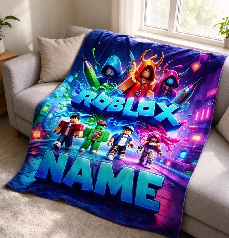 May include: A soft plush throw blanket featuring a vibrant Roblox graphic with multiple block-style characters, neon green paint splatters, and large blue 3D text that reads ROBLOX and NAME. The design includes a dark purple and blue background.