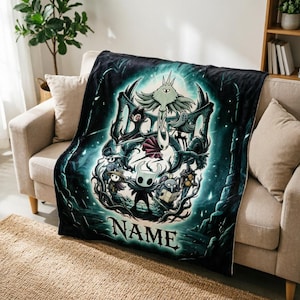 May include: A soft fleece throw blanket featuring a dark, teal-toned graphic illustration of characters from the video game Hollow Knight, including the Knight and Hornet, with the word NAME printed in a bold, stylized font at the bottom centre.
