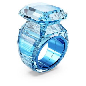 May include: A large, light blue ring with a rectangular gemstone. The ring has a faceted design, with a bright blue band. The gemstone is a clear, light blue color.