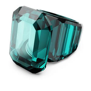 May include: A teal-colored, faceted ring with an emerald cut design. The ring is made of a transparent material, reflecting light and creating a sparkling effect. The ring's design is geometric and modern, suitable for fashion jewelry.