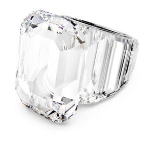 May include: A large, clear, emerald-cut ring with multiple facets. The ring is made of a transparent material, reflecting light and creating a sparkling effect. The design is modern and elegant, suitable for special occasions.