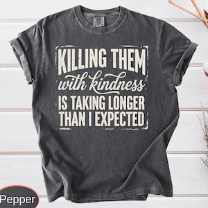 A vintage-wash premium t-shirt highlighting a witty, distressed quote about kindness taking too long, styled with a cool retro grunge aesthetic.