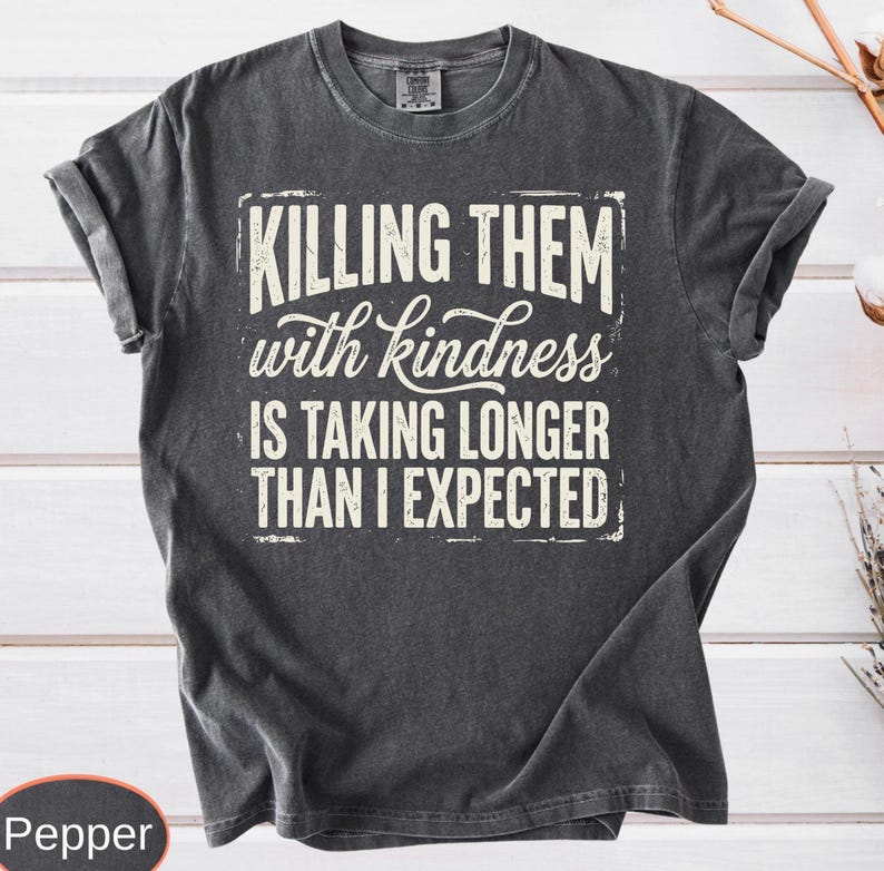 A vintage-wash premium t-shirt highlighting a witty, distressed quote about kindness taking too long, styled with a cool retro grunge aesthetic.