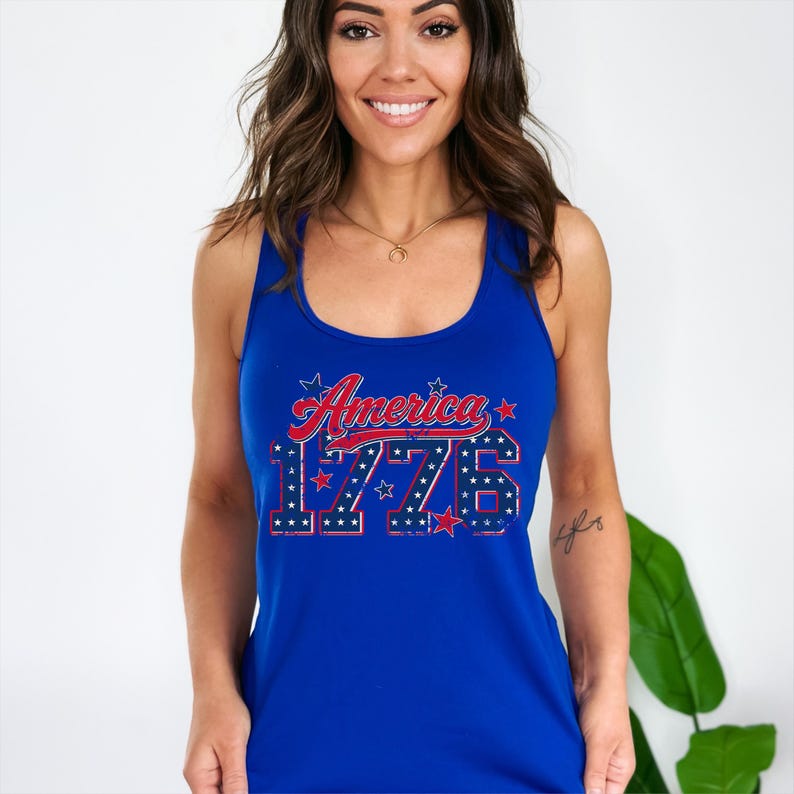 May include: A royal blue tank top with the words "America 1776" in red and white. The text features a patriotic design with stars. The tank top is sleeveless and has a scoop neck.