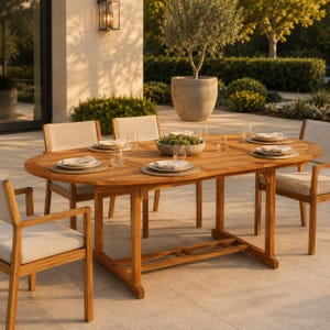 May include: An oval wooden dining table with a natural finish and a trestle base, surrounded by four wooden armchairs featuring light beige upholstered seat cushions. Each place setting includes a round woven placemat, a white plate, and a glass.