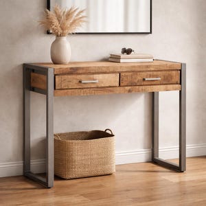 May include: A wooden console table with two drawers and a metal frame. A woven basket sits below the table. A vase with dried flowers and a mirror are above the table.