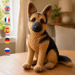 May include: A crocheted German Shepherd dog plush toy featuring a tan and black yarn color pattern, pointed ears, a dark muzzle, and black plastic eyes. The stuffed animal is sitting in an upright position with its tail extended to the side.