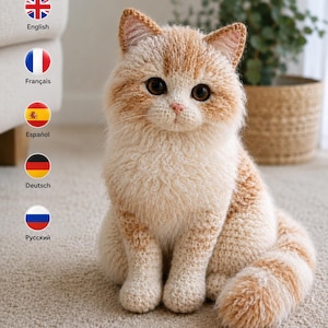 May include: A crocheted cat figurine featuring a cream and ginger-colored yarn texture. The cat has large dark brown eyes, a small pink nose, and pointed ears. It is depicted in a seated position with its tail curled around its side.
