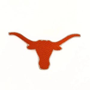 May include: Embroidered patch featuring the University of Texas Longhorns logo. The logo is a burnt orange longhorn head with a white outline. The patch is likely for apparel or accessories, and is set against a white background.