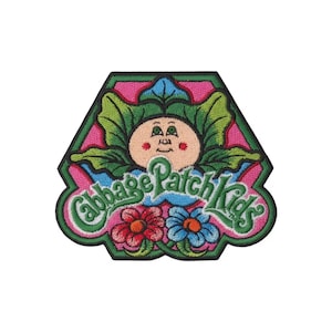 May include: Embroidered patch featuring a Cabbage Patch Kids design. The patch has a pink and green border, with a cartoon face surrounded by green leaves. The words "Cabbage Patch Kids" are in green script, with two flowers at the bottom.