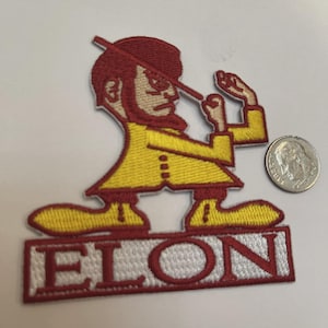 May include: Embroidered patch featuring a cartoon figure in a yellow coat and red hair, holding a stick. The patch has the word "ELON" in red letters on a white background. A U.S. dime is next to the patch for size comparison.