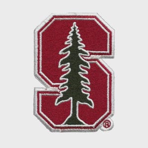 May include: Embroidered patch featuring a stylized green pine tree within a red letter "S". The "S" has a white border and a red background. A small registered trademark symbol is in the lower right corner.