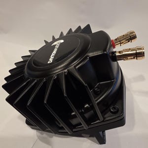 May include: A black Dayton Audio speaker component with a finned heat sink design. The component has gold-coloured connectors and a black base. The Dayton Audio logo is visible on the top.