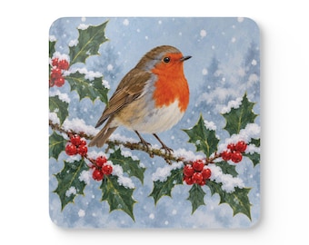 May include: A square coaster featuring a detailed illustration of a robin with a bright orange-red breast perched on a snow-covered holly branch. The scene includes dark green holly leaves, clusters of red berries, and a soft light blue background.