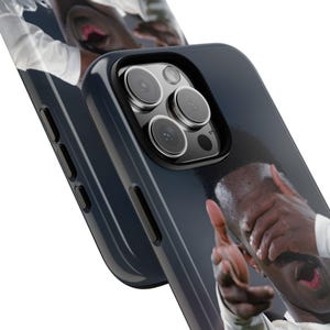 May include: A dark blue smartphone case featuring a printed graphic of a person with their hands covering their face and mouth. The case has a cutout for a triple-lens camera system and black side buttons. The design wraps around the edges of the case.