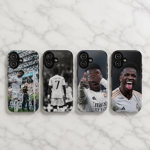 May include: Four rectangular phone cases featuring photographic prints of a soccer player. The designs include a player on a field, a player from behind wearing a jersey with the text VINI JR. 7, a player gesturing, and a player smiling with tongue out.