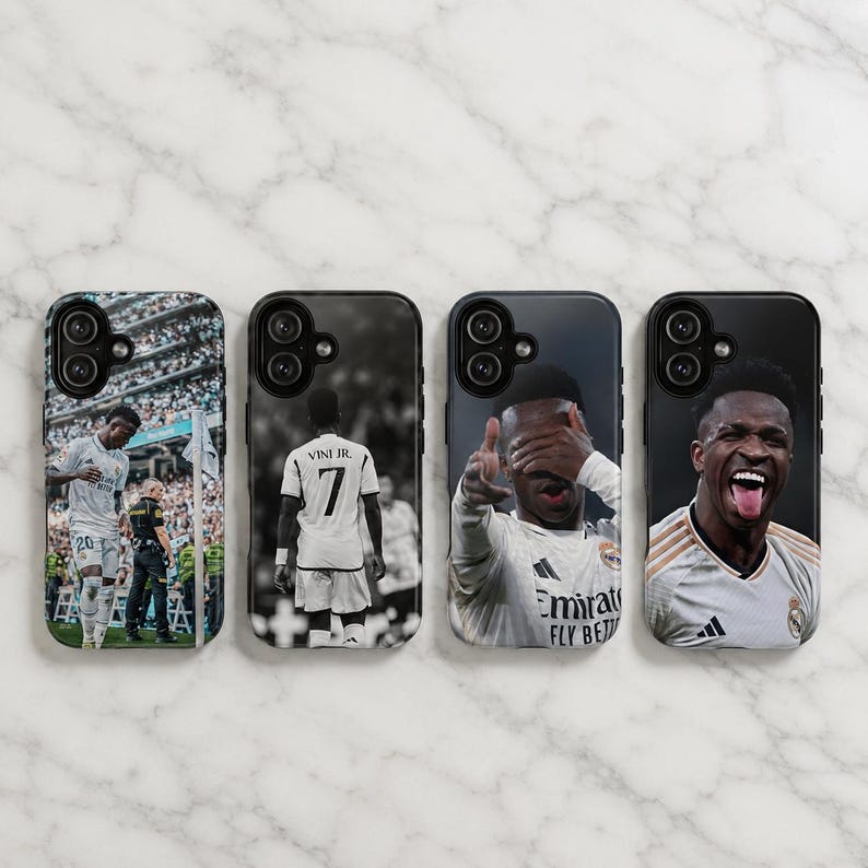 May include: Four rectangular phone cases featuring photographic prints of a soccer player. The designs include a player on a field, a player from behind wearing a jersey with the text VINI JR. 7, a player gesturing, and a player smiling with tongue out.