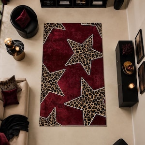 May include: A rectangular area rug featuring a deep burgundy background with large, five-pointed star shapes. The stars are filled with a brown and black leopard print pattern and outlined with thin white borders, creating a bold contrast.