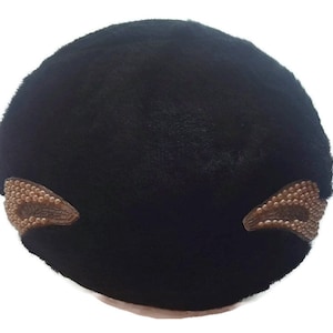 May include: Black velvet beret with two decorative brown beaded embellishments.