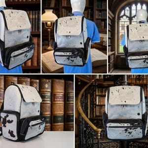 Puede incluir: Una mochila con un patr&oacute;n de piel de vaca en blanco y negro, con una solapa superior, un bolsillo frontal con cremallera y paneles laterales negros. La bolsa incluye correas ajustables para los hombros y un dise&ntilde;o estructurado con textura moteada.