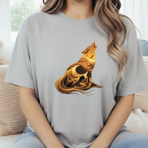 A woman in a grey t-shirt showcasing the modern double-exposure wolf art with sharp geometric vectors and desert textures.