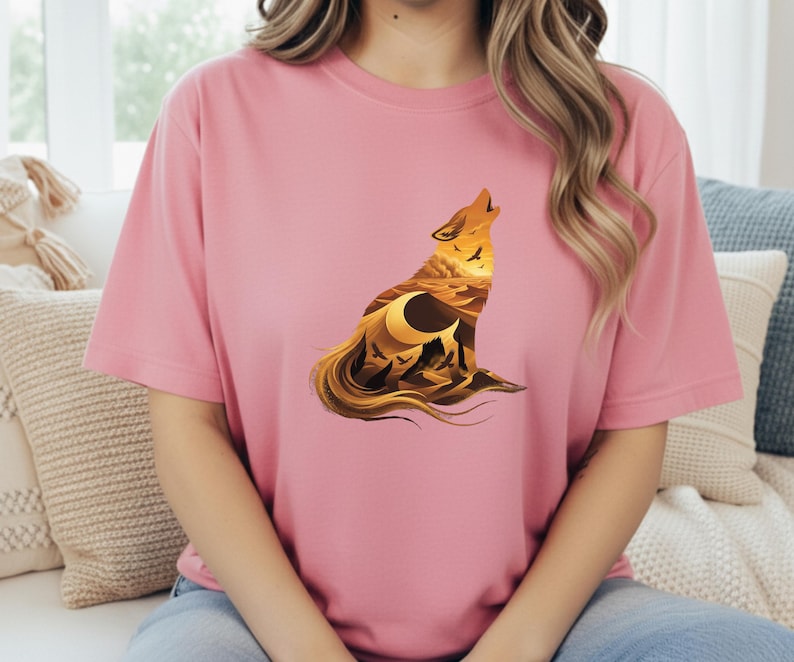 A woman wearing a soft pink t-shirt showcasing the high-contrast desert silhouette in shades of amber and black.