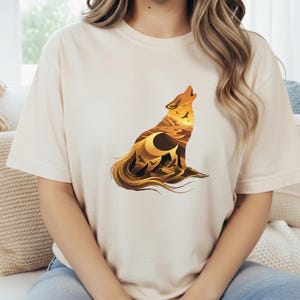 A woman in a cream-colored t-shirt that complements the warm earth tones and sun-drenched aesthetic of the desert wolf design.
