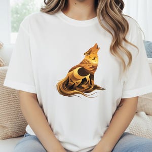 A woman in a white t-shirt where the vibrant golden and burnt sienna colors of the desert design stand out with maximum clarity.