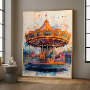 May include: A framed watercolour painting of a carousel. The carousel has a gold-coloured roof and is decorated with lights. The carousel horses are painted in shades of orange, blue, and pink. The background features a colourful sky and buildings.