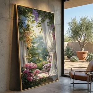 May include: A framed artwork depicts a serene outdoor scene. The painting showcases a window draped with white curtains, framing a lush garden with pink and purple flowers. The artwork is encased in a gold frame, leaning against a concrete wall.