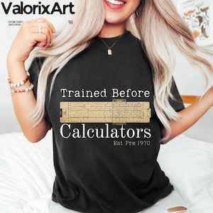 May include: A white ceramic mug with a black handle and the text "But First, Coffee" in a bold, black font. The mug is set against a blurred background, suggesting a cozy setting. The mug appears to be approximately 4 inches tall.