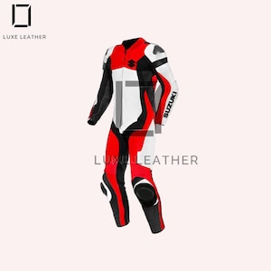 May include: A red, white, and black motorcycle racing suit with the Suzuki logo on the sleeve. The suit has a streamlined design with reinforced padding on the knees and shoulders. The Luxe Leather logo is visible.