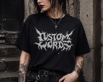 May include: A black short-sleeve t-shirt featuring the text CUSTOM WORDS in a white, jagged, metal-style font across the chest. The shirt has a crew neckline and is paired with black denim jeans featuring a black belt and a silver chain accessory.