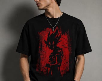 May include: A black short-sleeved t-shirt featuring a graphic print of a spiky-haired anime character silhouette in black against a distressed, textured red rectangular background. The design is centered on the chest of the garment.