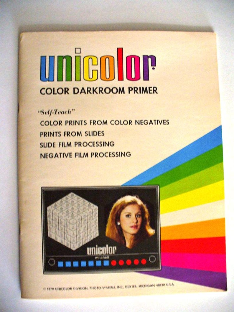 May include: A vintage Unicolor Color Darkroom Primer instructional booklet with a rainbow-striped design. The cover features the text "Self-Teach" and lists darkroom processes, including a graphic of a cube and a portrait of a person.