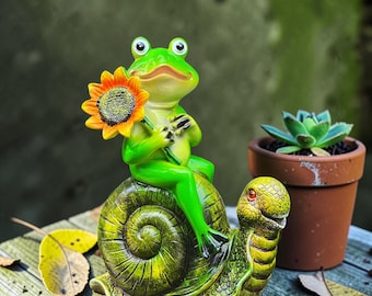 Tecknad groda ridande snigel trädgårdsstaty, harts utomhusskulpturdekoration