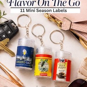 May include: Three clear plastic cylindrical containers attached to metal keychains. The labels read Flavor On The Go, 11 Mini Season Labels, Iodized Salt with a yellow figure, Slap Original Blend, and Pure Ground Black Pepper with a pepper graphic.