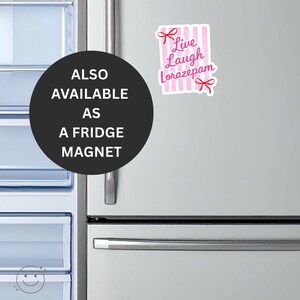 May include: A fridge magnet with the text "Live Laugh Lorazepam" in pink script, set against a pink and white striped background. The magnet is adorned with pink bow accents. The image also includes a black circle with the text "ALSO AVAILABLE AS A FRIDGE MAGNET".