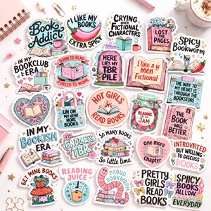 May include: A collection of colorful stickers with book-themed designs. The stickers feature phrases like "Book Addict," "Hot Girls Read Books," and "Spicy Bookworm." Various illustrations include books, hearts, and food items. The stickers are ideal for decorating notebooks or journals.