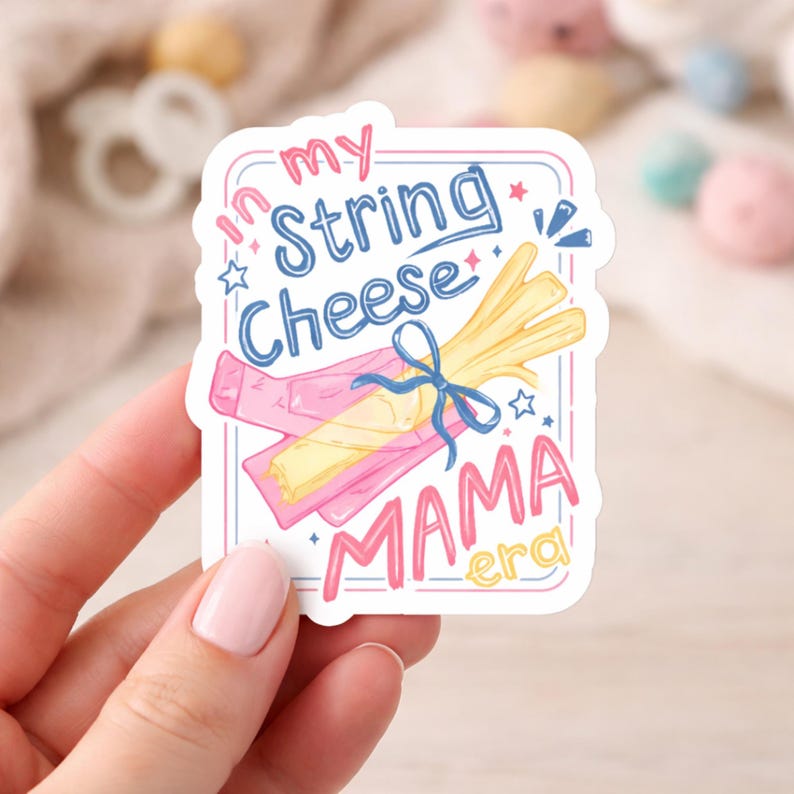 May include: A sticker with the text "In my String Cheese Mama Era." The design features illustrations of string cheese, a pink cheese wrapper, and stars. The text is in blue and pink.