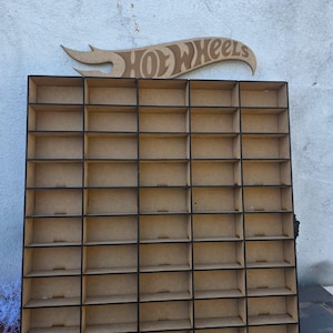 May include: A wooden display case with multiple small compartments, perfect for organizing and showcasing collectible toy cars. The case has a dark border and a wooden Hot Wheels logo at the top.