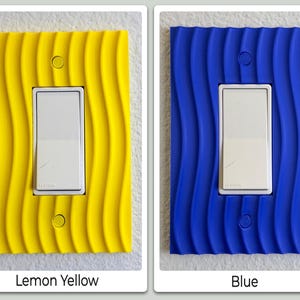 May include: Two light switch covers, one lemon yellow and one blue, each with a wavy, textured design. The switches are white. The yellow cover is labeled "Lemon Yellow" and the blue cover is labeled "Blue".