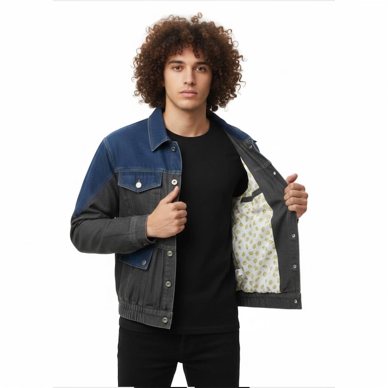 May include: A two-tone denim jacket with a blue upper section and a gray lower section. The jacket has a classic collar, button closures, and pockets. The interior lining features a light-colored pattern.