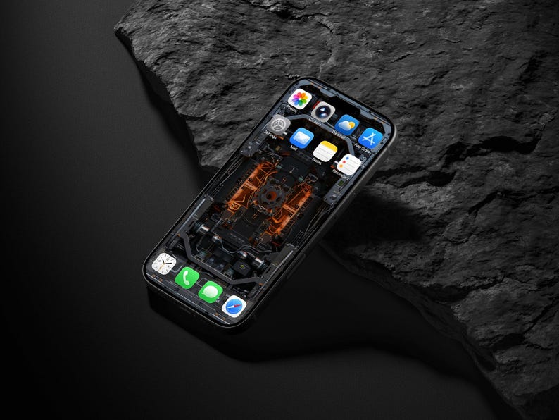 May include: A smartphone with a black frame and a screen displaying a digital wallpaper of internal mechanical components in orange and black. The interface shows standard app icons including Photos, Camera, Settings, Mail, Notes, App Store, Clock, Phone, Messages, and Safari.