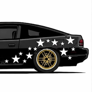 May include: Black car with white star decals on the side. The car has a gold rimmed wheel. The car is set against a white background.